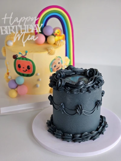 Black vintage buttercream cake with ornate piping