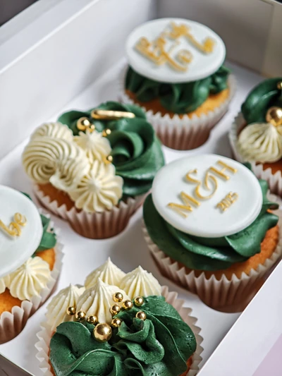 Luxury green and gold cupcakes with personalised monogram toppers