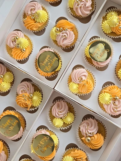 Mother's Day cupcakes with gold toppers and pastel buttercream swirls