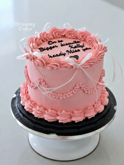 Pink vintage buttercream message cake with ribbon details